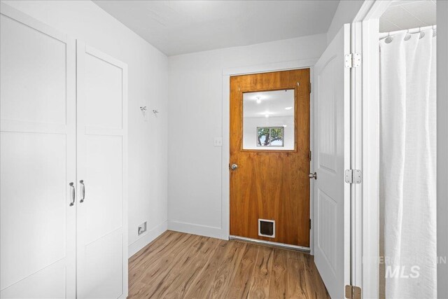 doorway with light wood-type flooring