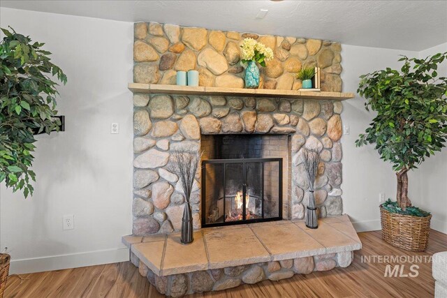 details with a fireplace and wood-type flooring