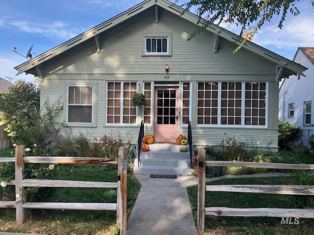 view of front of property featuring entry steps and fence