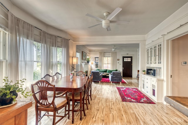 dining area featuring light wood-style floors and a ceiling fan