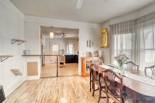 dining room with light wood-style flooring, baseboards, and visible vents