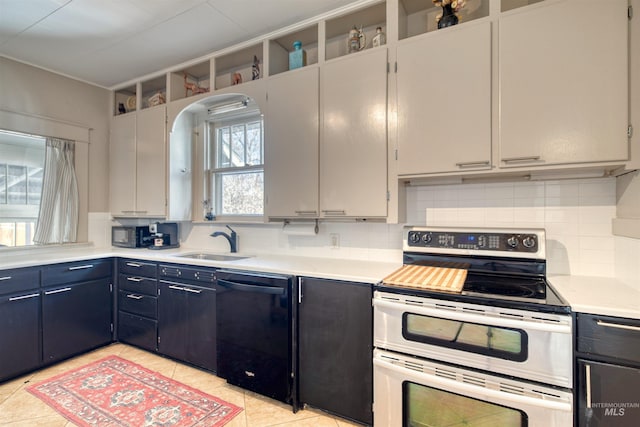 kitchen with dishwasher, light countertops, double oven range, and a sink