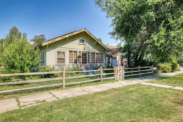 view of front of house featuring a fenced front yard and a front lawn