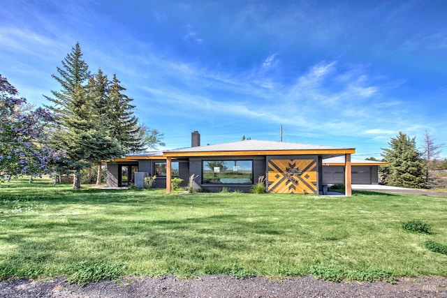 2672 E 4000 N, Twin Falls, ID 83301 - back of property featuring a lawn, a chimney, and a garage