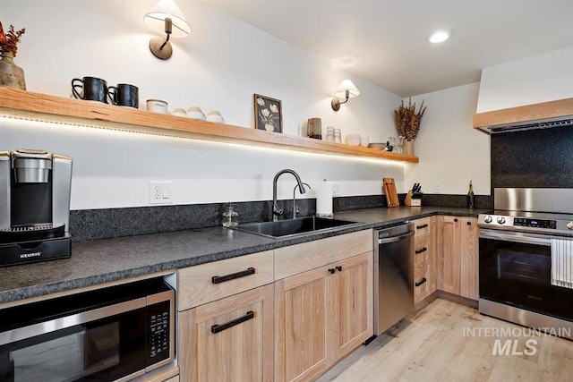 2672 E 4000 N, Twin Falls, ID 83301 - kitchen with light brown cabinets, stainless steel appliances, a sink, open shelves, and light wood-style floors