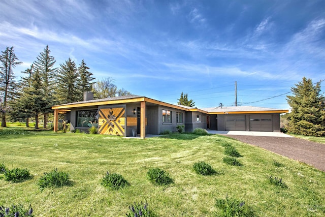 2672 E 4000 N, Twin Falls, ID 83301 - view of front facade with an attached garage, asphalt driveway, a front yard, and a chimney
