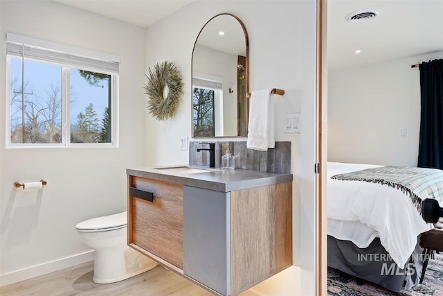 2672 E 4000 N, Twin Falls, ID 83301 - bathroom featuring vanity, wood finished floors, toilet, baseboards, and recessed lighting