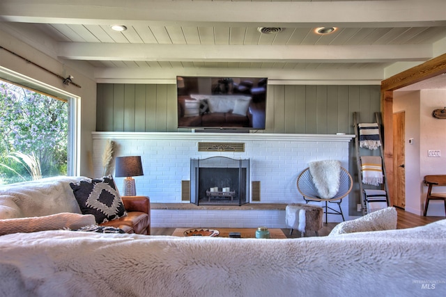 2672 E 4000 N, Twin Falls, ID 83301 - living area featuring wood finished floors, a brick fireplace, and wooden ceiling with exposed beams