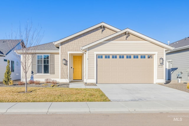 view of front of house featuring a front yard and a garage