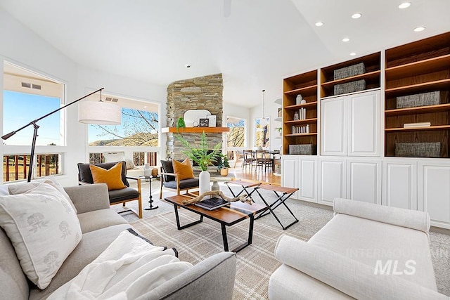 living room with a healthy amount of sunlight and a fireplace