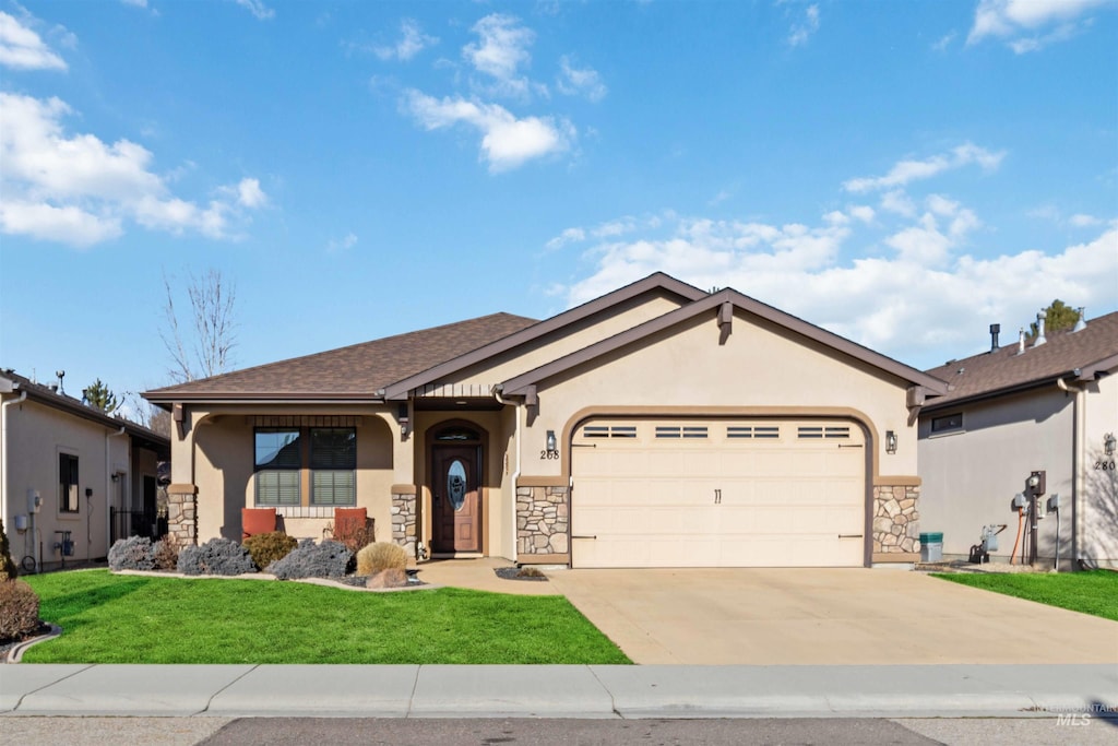 view of front of home with a garage and a front lawn