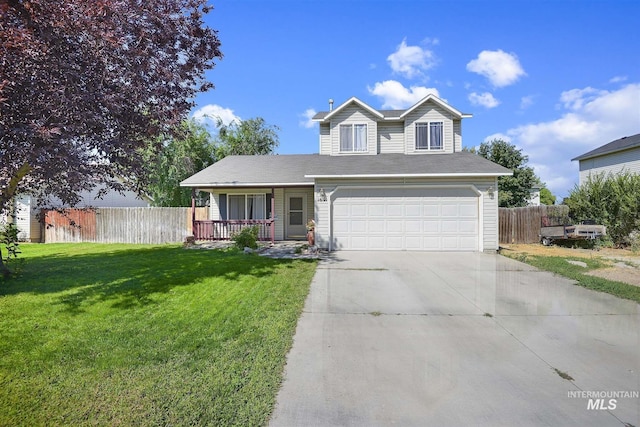 traditional-style house featuring fence, a garage, a front yard, concrete driveway, and covered porch