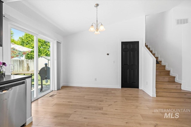 unfurnished dining area featuring visible vents, light wood-style flooring, stairs, and an inviting chandelier