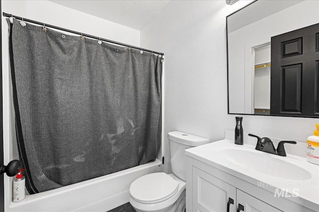 bathroom with vanity, shower / bath combination with curtain, and toilet
