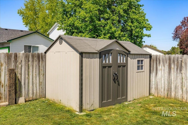 view of shed featuring fence