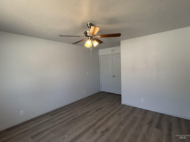 1150 NW 22nd St, Fruitland, ID 83619 - spare room with dark wood-style flooring, ceiling fan, and a textured ceiling