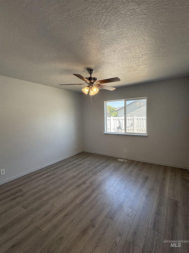 1150 NW 22nd St, Fruitland, ID 83619 - spare room with dark wood finished floors, a textured ceiling, and a ceiling fan