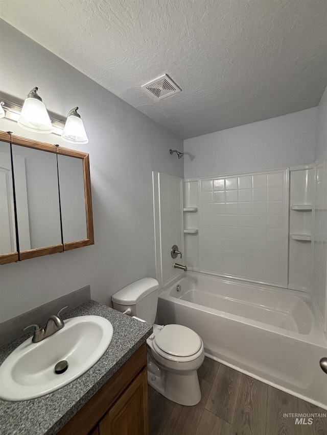 1150 NW 22nd St, Fruitland, ID 83619 - bathroom featuring wood finished floors, vanity, shower / tub combination, and a textured ceiling