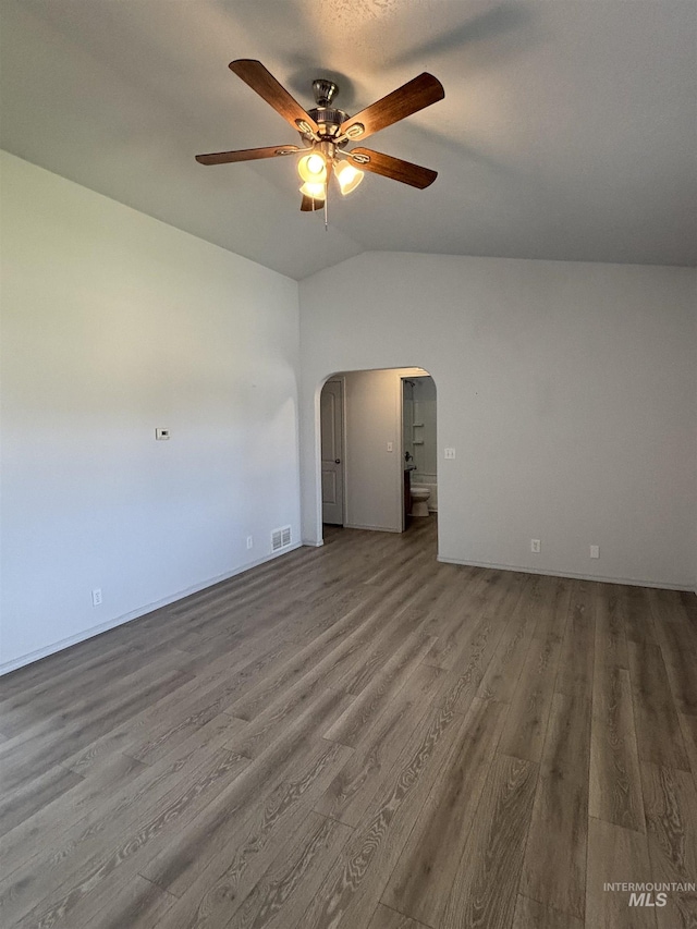 1150 NW 22nd St, Fruitland, ID 83619 - unfurnished room with arched walkways, ceiling fan, vaulted ceiling, and wood finished floors