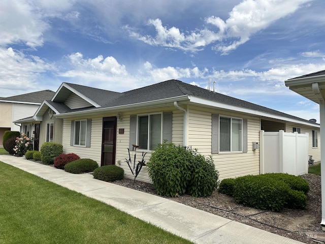 168 Long Is, Twin Falls, ID 83301 - single story home featuring a front yard, fence, and a shingled roof