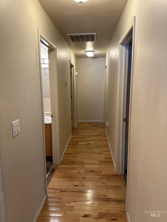 168 Long Is, Twin Falls, ID 83301 - corridor with visible vents, baseboards, and light wood-style flooring