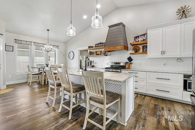 910 Blueridge Dr, Kimberly, ID 83341 - kitchen featuring open shelves, gas range, premium range hood, tasteful backsplash, and white cabinetry