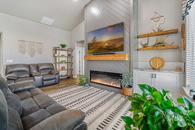 910 Blueridge Dr, Kimberly, ID 83341 - living area featuring vaulted ceiling, a glass covered fireplace, and wood finished floors