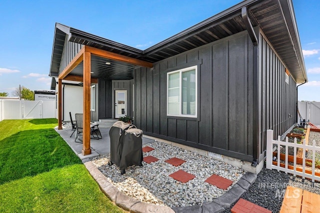 910 Blueridge Dr, Kimberly, ID 83341 - back of property with board and batten siding, a patio, and a gate