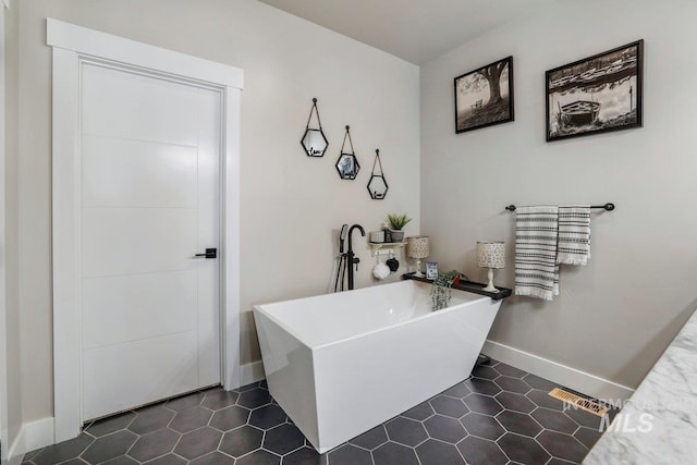 910 Blueridge Dr, Kimberly, ID 83341 - bathroom featuring a freestanding tub, baseboards, and tile patterned flooring