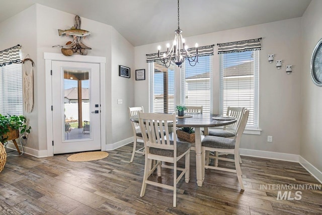 910 Blueridge Dr, Kimberly, ID 83341 - dining area featuring a chandelier, hardwood / wood-style floors, baseboards, and lofted ceiling