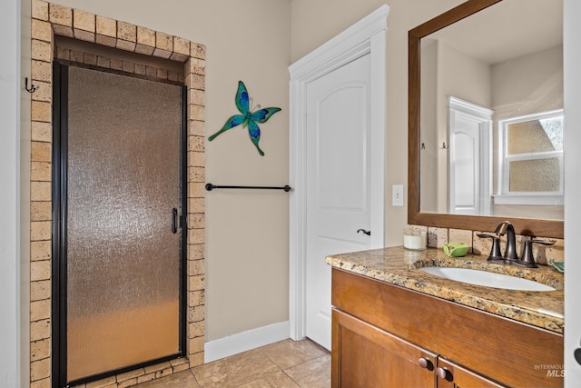 bathroom with vanity, tile patterned floors, and a shower with door