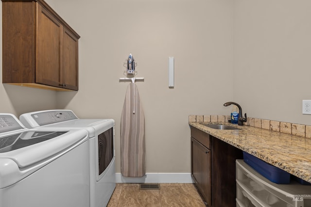 laundry room with cabinets, separate washer and dryer, light tile patterned flooring, and sink