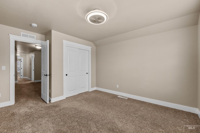 unfurnished bedroom with carpet flooring and a closet