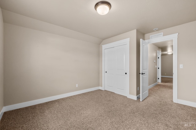 unfurnished bedroom with a closet and carpet floors