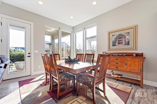 dining area with a wealth of natural light and light hardwood / wood-style floors