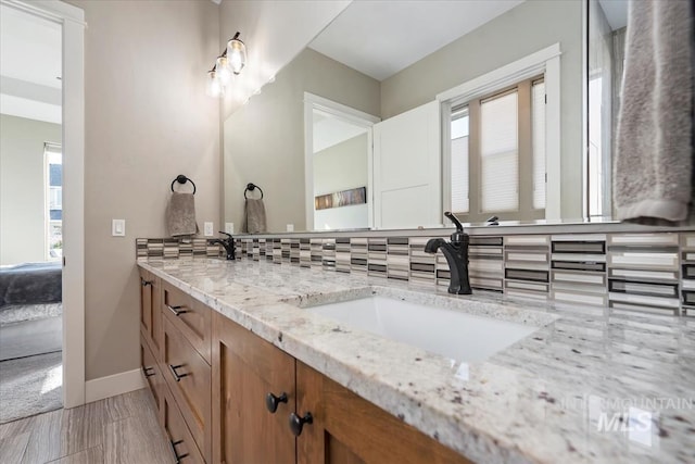 bathroom featuring vanity and backsplash