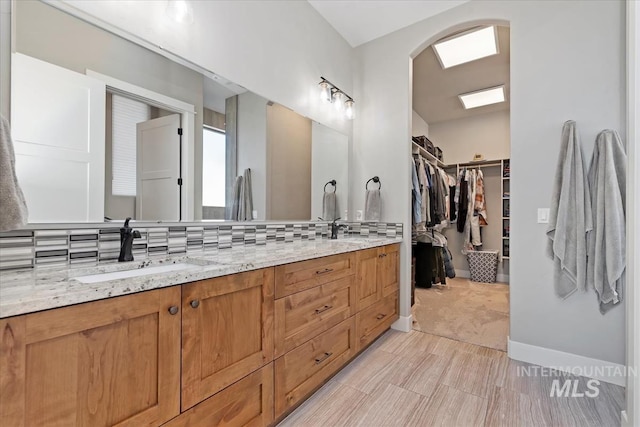 bathroom with vanity and decorative backsplash