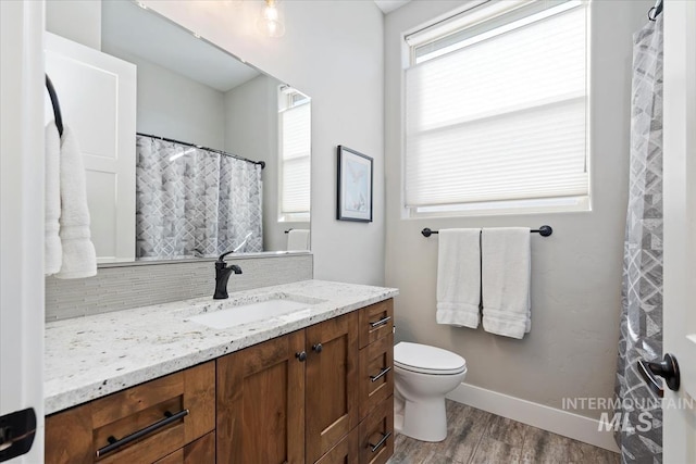 bathroom with hardwood / wood-style flooring, vanity, and toilet