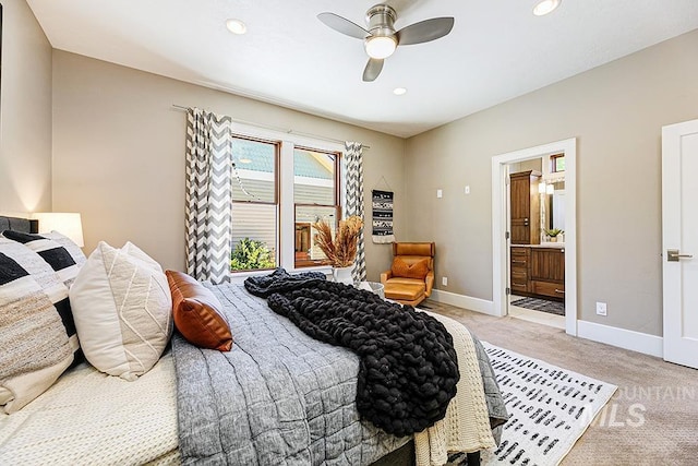 bedroom with light colored carpet, baseboards, recessed lighting, ensuite bathroom, and a ceiling fan