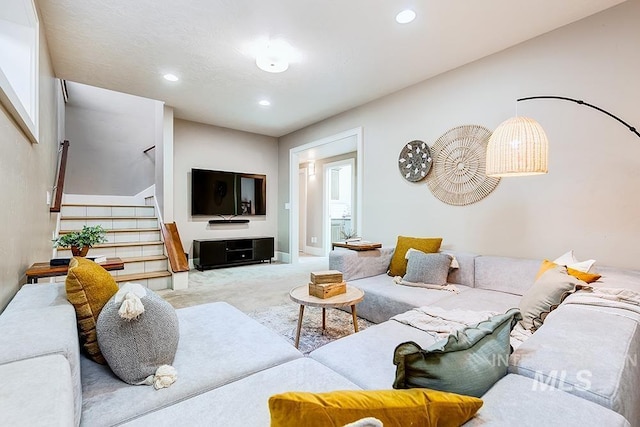 living area featuring carpet, stairway, and recessed lighting