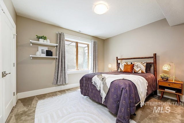 bedroom featuring carpet and baseboards