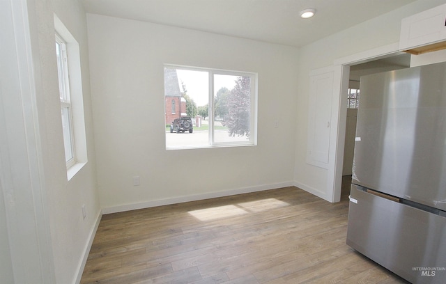 324 Nectarine, Nampa, ID 83686 - kitchen with freestanding refrigerator, light wood-style floors, white cabinets, and recessed lighting