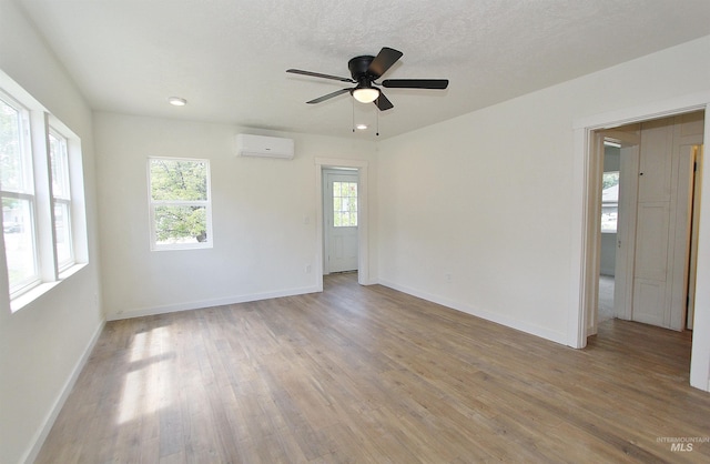 324 Nectarine, Nampa, ID 83686 - empty room with light wood finished floors, a ceiling fan, and an AC wall unit