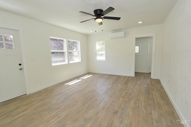 324 Nectarine, Nampa, ID 83686 - unfurnished room with a wall mounted AC, light wood-type flooring, and ceiling fan