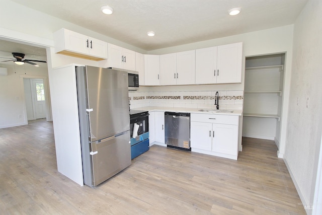 324 Nectarine, Nampa, ID 83686 - kitchen with stainless steel appliances, light countertops, white cabinets, light wood-style floors, and recessed lighting