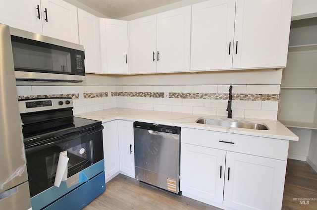 324 Nectarine, Nampa, ID 83686 - kitchen with stainless steel appliances, decorative backsplash, light wood-style flooring, and white cabinetry