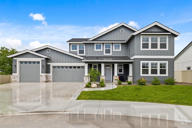 craftsman inspired home featuring board and batten siding, a porch, a standing seam roof, a front yard, and an attached garage