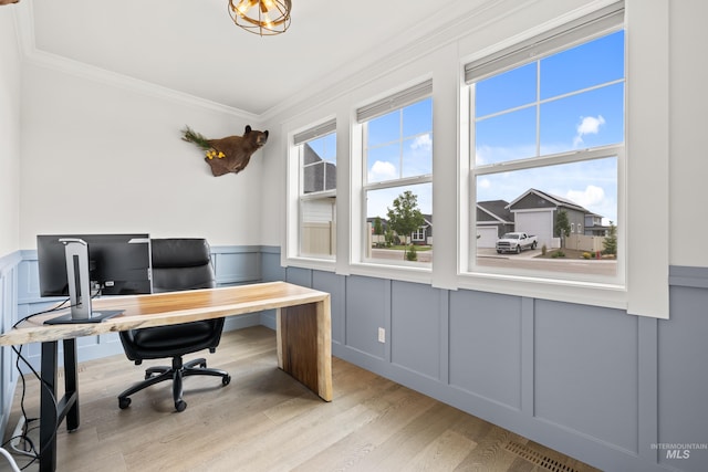 office with wood finished floors, ornamental molding, a decorative wall, and a wainscoted wall