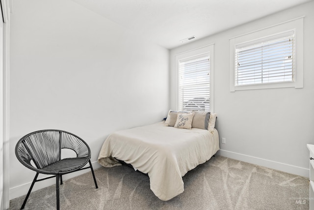 bedroom with carpet flooring, baseboards, and visible vents