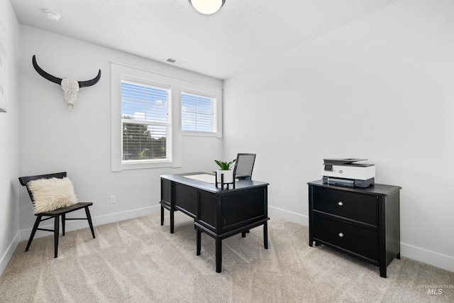 office area featuring visible vents, baseboards, and light colored carpet